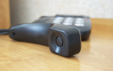 Black phone receiver on the table